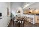 This dining area is adjacent to the kitchen and features a table, six chairs, and modern lighting at 6450 W 44Th Pl # B3, Wheat Ridge, CO 80033