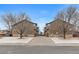 Exterior shot of two multi-Gathering dwellings with brick foundation, yards, and garages at 6450 W 44Th Pl # B3, Wheat Ridge, CO 80033
