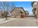 View of multi-Gathering home's exterior, featuring garages, landscaping, and clean design at 6450 W 44Th Pl # B3, Wheat Ridge, CO 80033