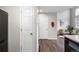Hallway with hardwood floors leading to a living room with gray sofa and stylish decor in this modern home at 6450 W 44Th Pl # B3, Wheat Ridge, CO 80033
