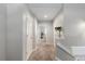Long hallway with neutral carpet, white doors, and natural light from adjacent rooms at 6450 W 44Th Pl # B3, Wheat Ridge, CO 80033