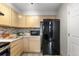 The kitchen features wooden cabinets, a mosaic backsplash, and stainless steel appliances for a modern touch at 6450 W 44Th Pl # B3, Wheat Ridge, CO 80033