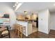 Kitchen area with bar seating, modern appliances, neutral countertops and lighting throughout at 6450 W 44Th Pl # B3, Wheat Ridge, CO 80033
