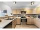 This kitchen features neutral countertops, a stainless steel oven, and mosaic backsplash at 6450 W 44Th Pl # B3, Wheat Ridge, CO 80033