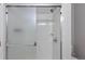 Shower has frosted glass doors and white tile at 6450 W 44Th Pl # B3, Wheat Ridge, CO 80033