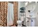 Well-lit bathroom featuring a pedestal sink, modern fixtures, and a shower with patterned curtain at 3872 S Dallas St # 7-307, Aurora, CO 80014