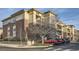 Multi-story condo building showcasing brick and siding details, complimented by mature trees at 3872 S Dallas St # 7-307, Aurora, CO 80014