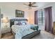 Comfortable bedroom with plush bedding, serene decor, and a bright window view at 3872 S Dallas St # 7-307, Aurora, CO 80014