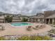 Community pool surrounded by lounge chairs for relaxation; an outdoor oasis for residents to enjoy at 3872 S Dallas St # 7-307, Aurora, CO 80014