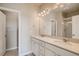 Bright bathroom features double vanity, modern fixtures and a glass enclosed shower at 6837 Huddersfield Ln, Castle Pines, CO 80108