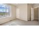 Sunlit bedroom shows neutral walls, carpet and a view from the window at 6837 Huddersfield Ln, Castle Pines, CO 80108