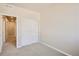 Spacious bedroom with neutral carpet and view into hallway at 6837 Huddersfield Ln, Castle Pines, CO 80108