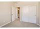 Bright bedroom features neutral finishes, closet and view into bathroom at 6837 Huddersfield Ln, Castle Pines, CO 80108