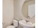 Clean, well-lit half bathroom with a modern sink and fixtures; perfect for guests at 6837 Huddersfield Ln, Castle Pines, CO 80108