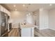 Contemporary kitchen featuring a large island, stainless steel appliances, and seamless living area integration at 6837 Huddersfield Ln, Castle Pines, CO 80108
