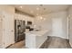 Modern kitchen with stainless steel appliances, center island, and ample cabinetry, perfect for cooking and storage at 6837 Huddersfield Ln, Castle Pines, CO 80108