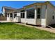The backyard shows a well-maintained lawn, complemented by the home's light exterior and large windows at 11144 Navajo St, Northglenn, CO 80234