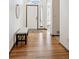 Inviting entryway with hardwood floors, white door with transom window, bench, and bright natural light at 11144 Navajo St, Northglenn, CO 80234