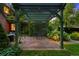Charming patio featuring an inviting outdoor seating area beneath a green pergola and lush greenery at 1960 Hudson St, Denver, CO 80220