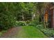 Picturesque backyard with mature trees, lush lawn, and beautiful garden beds create a private retreat at 1960 Hudson St, Denver, CO 80220