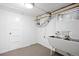 Unfinished basement with concrete floor, plumbing, a utility sink and a door to other areas at 1960 Hudson St, Denver, CO 80220