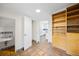 Finished basement with tile flooring, built-in shelving, and a small bathroom at 1960 Hudson St, Denver, CO 80220