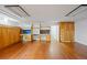Spacious basement featuring a hardwood floor, a utility closet, and custom built-ins with lots of storage at 1960 Hudson St, Denver, CO 80220