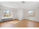 Bright bedroom features hardwood floors, two windows, and built-in shelving at 1960 Hudson St, Denver, CO 80220