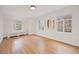 Large bedroom with hardwood floors, two windows, and views to the yard at 1960 Hudson St, Denver, CO 80220