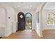 Inviting foyer with arched doorways and hardwood floors, leading to other areas of the home at 1960 Hudson St, Denver, CO 80220