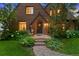 Charming brick home with a stone pathway leading to a cozy front porch with meticulous landscaping at 1960 Hudson St, Denver, CO 80220