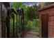 Ornate metal gate opens to a lush landscaped garden at 1960 Hudson St, Denver, CO 80220