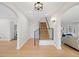 Hallway featuring hardwood floors, staircase, and views into the living room and kitchen at 1960 Hudson St, Denver, CO 80220