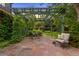 Outdoor patio with dining set under a wooden pergola and comfortable chair with decorative pillow at 1960 Hudson St, Denver, CO 80220