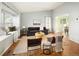 Bright living room featuring modern furniture, a large window seat, and hardwood flooring at 322 Mountain Cloud Cir, Highlands Ranch, CO 80126