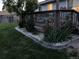 Backyard view featuring a small deck with stone and brick landscaping at 15756 E Temple Pl, Aurora, CO 80015