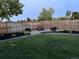 This backyard has an outdoor firepit and seating surrounded by black mulch and mature landscaping at 15756 E Temple Pl, Aurora, CO 80015