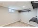 Functional basement room features carpet, mounted shelving and a small egress window at 15756 E Temple Pl, Aurora, CO 80015