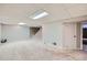 Large carpeted basement offers ample space with access to stairs, bathroom, and door to utility area at 15756 E Temple Pl, Aurora, CO 80015