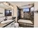 Basement bathroom featuring stone-look shower, jacuzzi tub, and modern vanity at 15756 E Temple Pl, Aurora, CO 80015