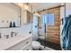 Stylish bathroom featuring a modern vanity, glass-enclosed shower with decorative tiles and black stone flooring at 15756 E Temple Pl, Aurora, CO 80015