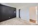Clean bedroom featuring carpet floors, closet storage, and a dark accent wall adding character to the room at 15756 E Temple Pl, Aurora, CO 80015