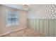 Charming bedroom with green wainscoting, a decorative polka dot wall, and a bright window at 15756 E Temple Pl, Aurora, CO 80015