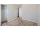 Well-lit bedroom with an open closet space and neutral walls complemented by soft carpeting at 15756 E Temple Pl, Aurora, CO 80015