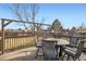 Relax on this outdoor deck, featuring a dining set with a built-in fire pit and backyard views at 15756 E Temple Pl, Aurora, CO 80015