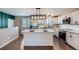 Contemporary kitchen featuring stainless steel appliances, ample cabinet space, and an island with seating at 15756 E Temple Pl, Aurora, CO 80015