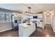 Modern kitchen with white cabinetry, stainless steel appliances, and a central island, ideal for culinary enthusiasts at 15756 E Temple Pl, Aurora, CO 80015