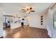 Open-concept living space showcasing hardwood floors, a modern ceiling fan, and seamless transitions to the kitchen at 15756 E Temple Pl, Aurora, CO 80015