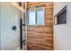 Updated shower featuring wood-look tile, window, inset decorated wall, and black fixtures at 15756 E Temple Pl, Aurora, CO 80015