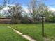 Expansive grassy backyard with trees and partial fencing, offering a serene outdoor space at 1890 Eaton St, Lakewood, CO 80214